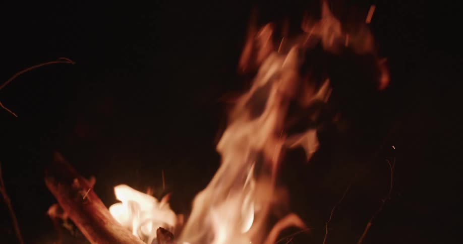 A bonfire is burning outdoors during the night time