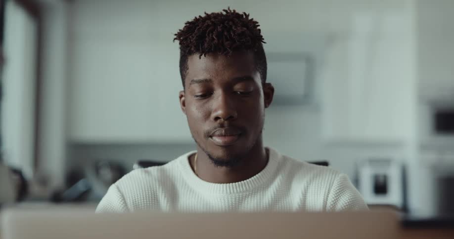 A man using a laptop in a room