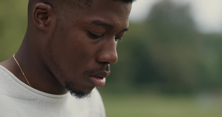 Young black mans head looking down outdoors during daylight