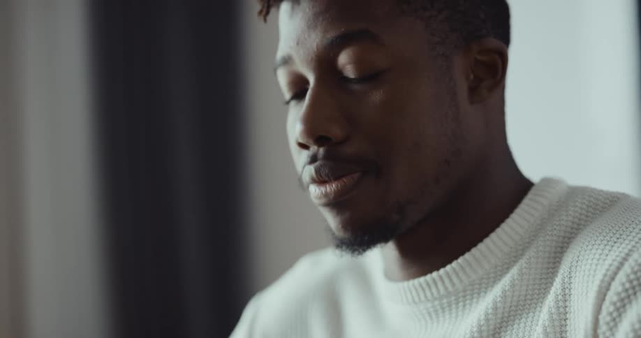 Frustated black man touching his face