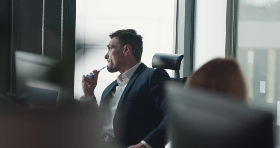 Two coworkers are sitting in an office together