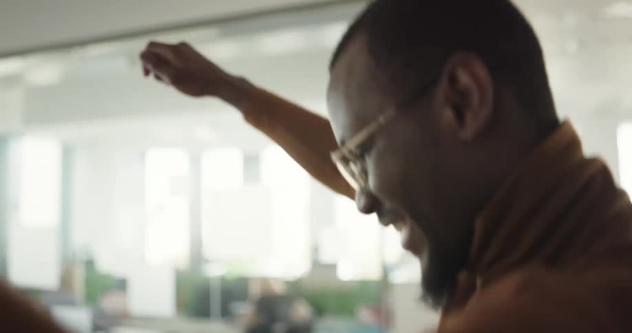 People are dancing in an office at their desks