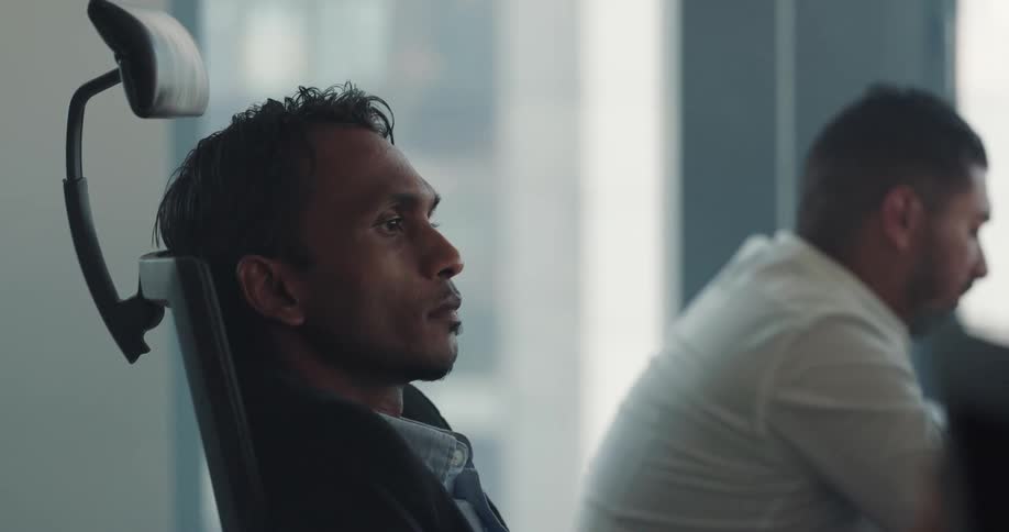 Indian man sitting on an office chair during an office meeting at the office space