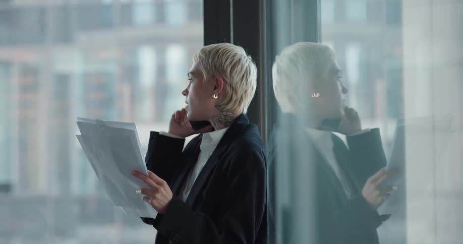A woman is talking on her cellphone in an office