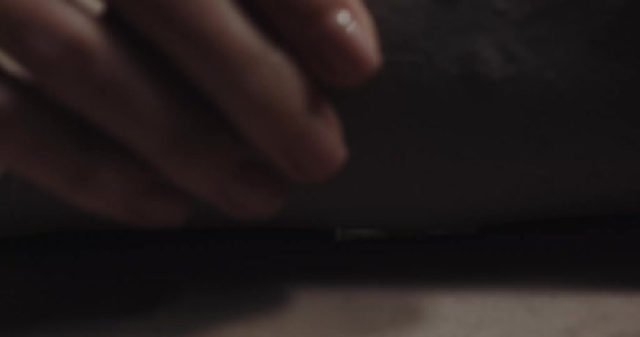 A person is pressing a flower cutter into the clay