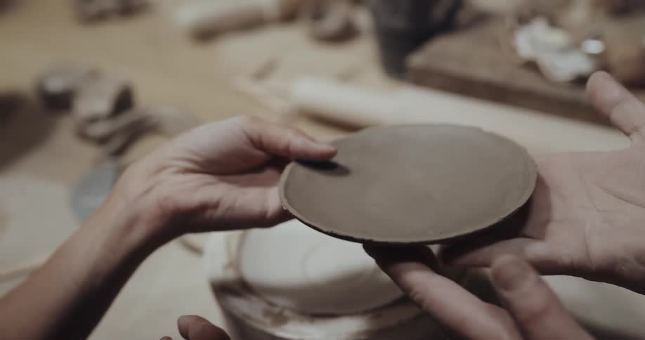 People are making plates with pottery