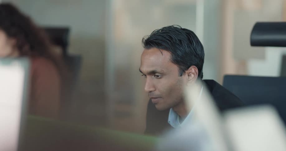 Businessman with suit bumps fists with coworker at the office