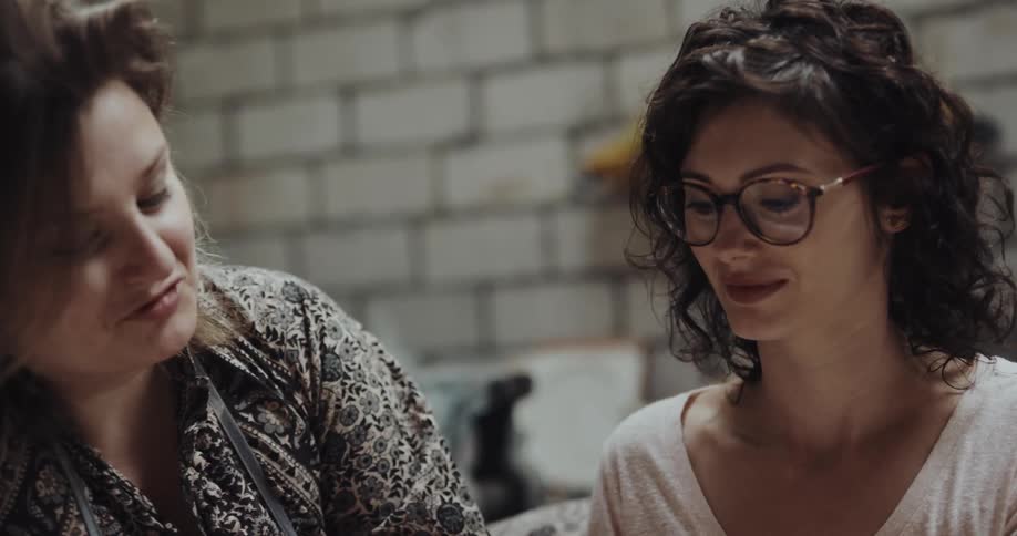 Two women are sculpting with clay