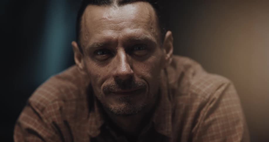A man is smiling in a room in his house