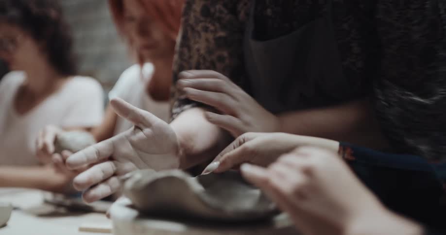 A group of women are making pottery together