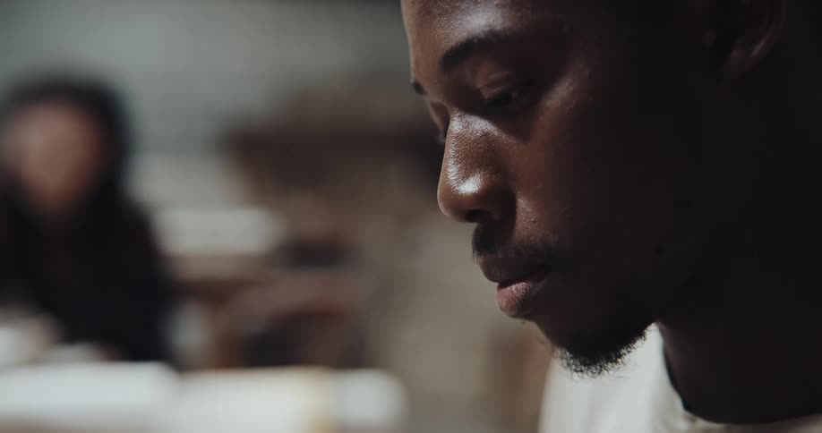 Close up view of a man talking to someone indoors