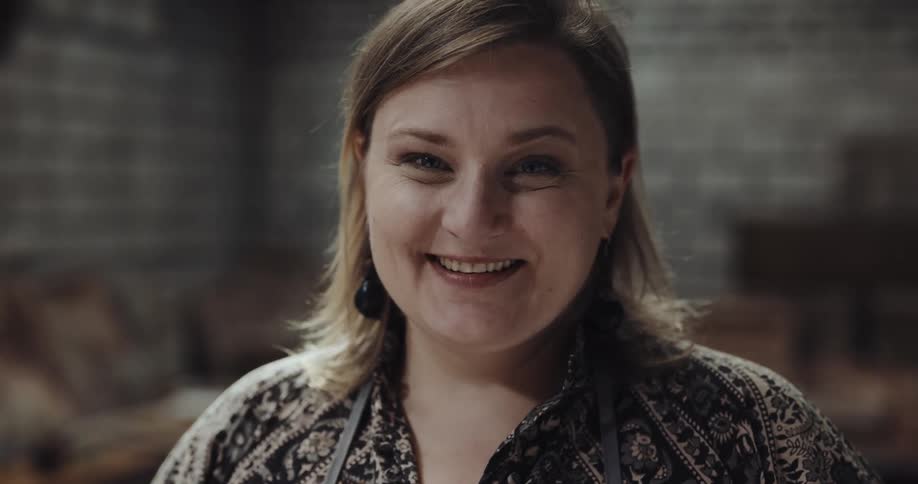 A woman smiles as she poses for the camera