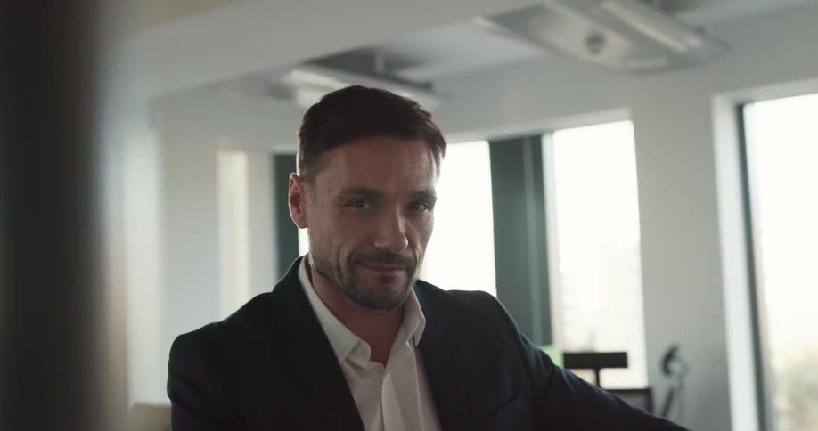 Handsome businessman smiling in an empty office