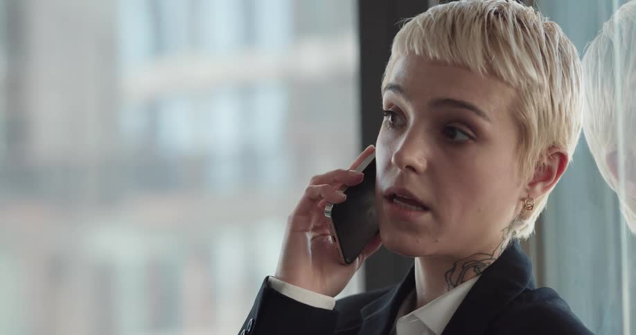 A woman is talking on a cellphone in her office building