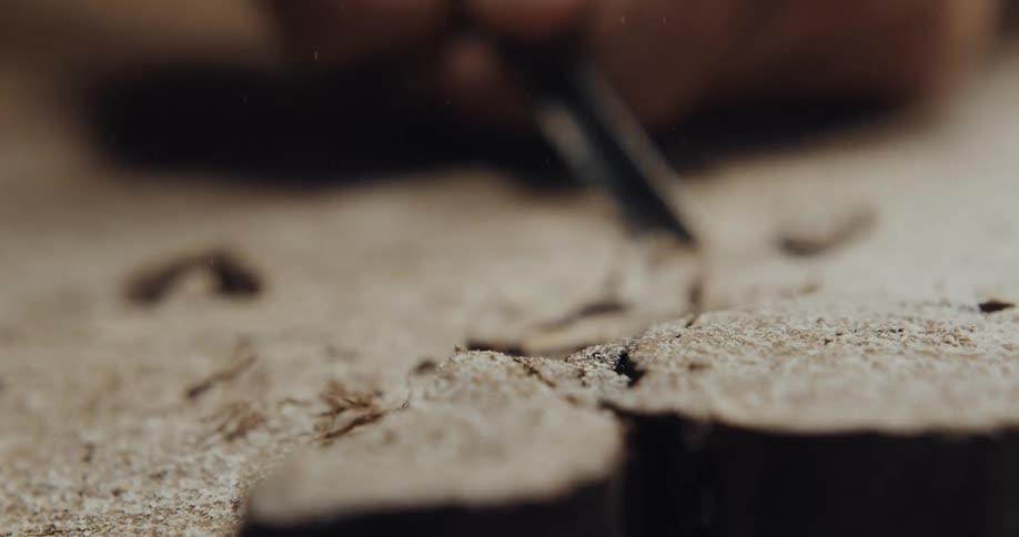 A person is carving a piece of wood