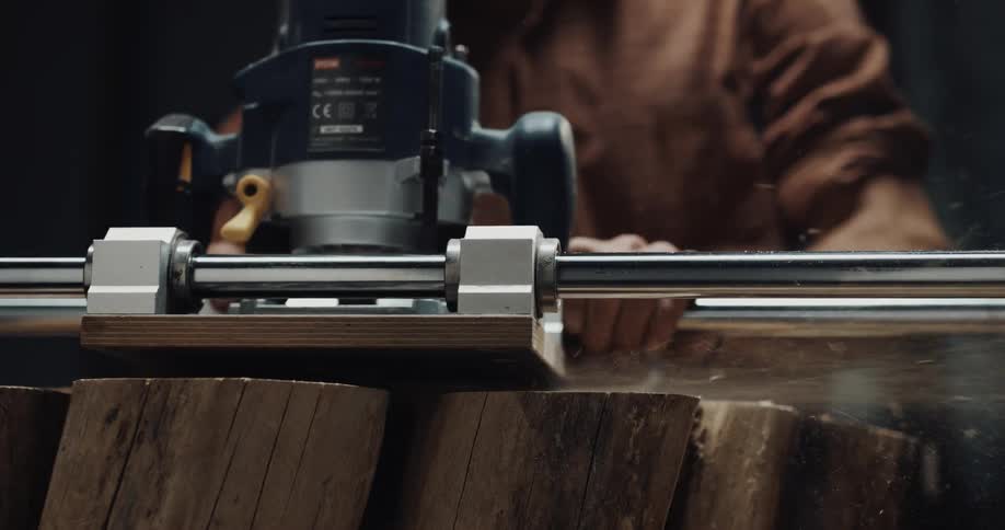 A man is using machinery to cut a tree