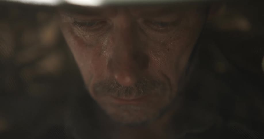 Close up view of a man wearing a hat is displayed