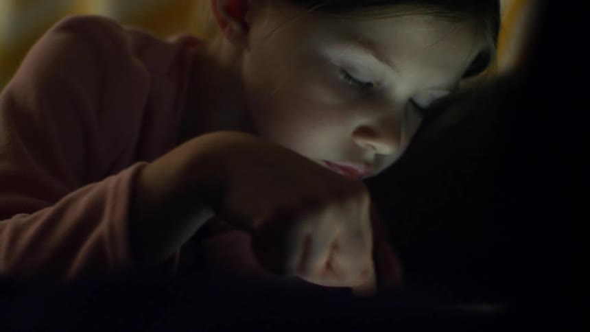 A girl swipes through a tablet
