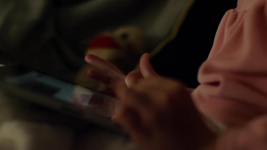 A child scrolls through a tablet