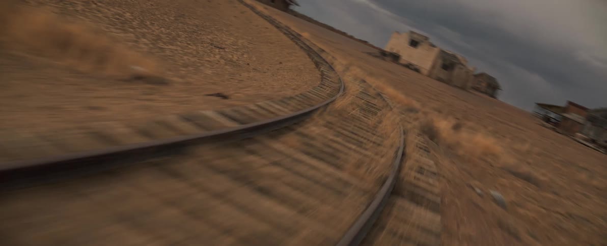 Aerial view of the train tracks close to an old wild west town