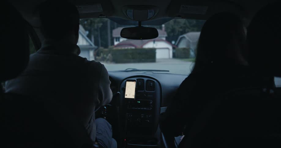 Rear interior POV of Two People Driving with GPS