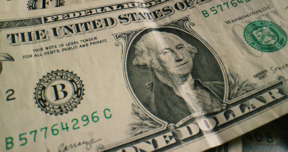 American paper currency in various denominations are thrown onto each other