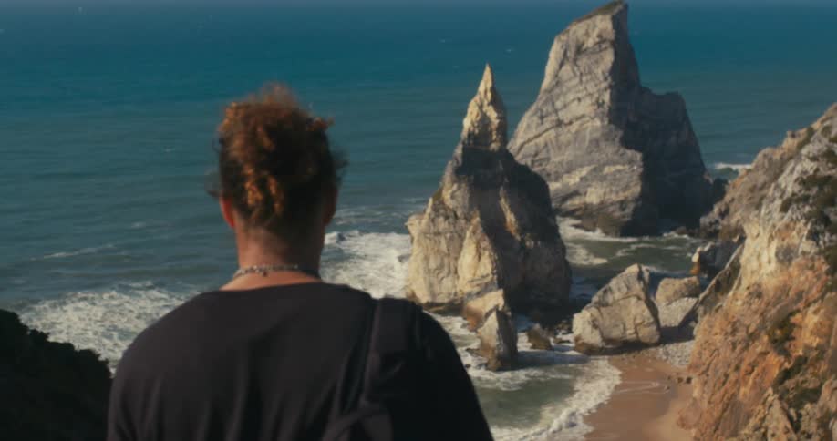 A person is hiking outdoors by the beach