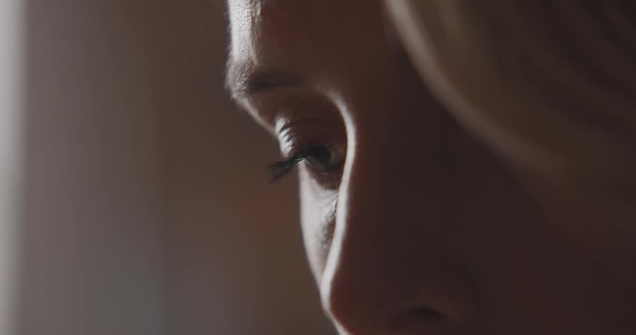 Close up of a womans face is displayed