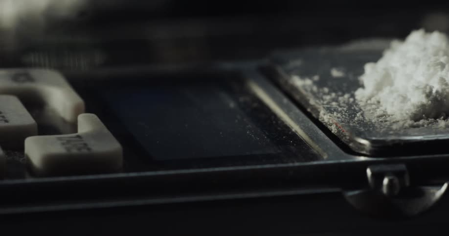 A brush is dusting off the edges of a tray