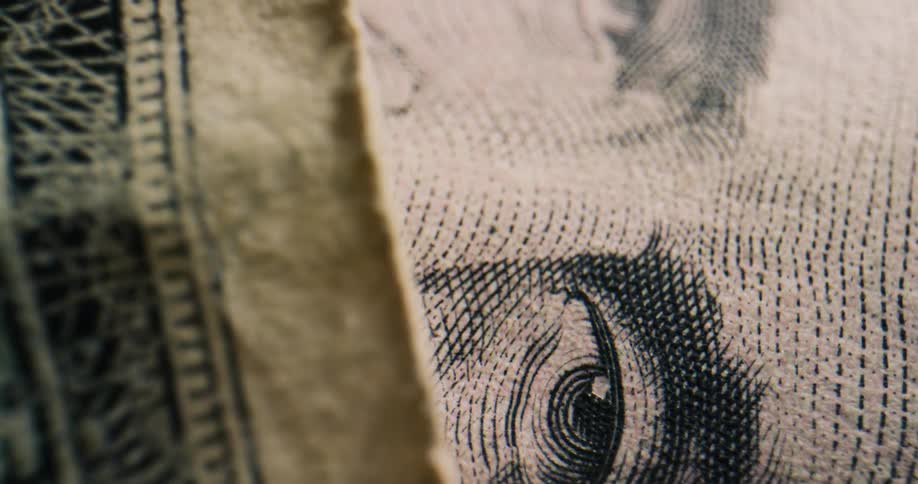Extreme close up of the imperfections on the surface and edge of united states dollar bills