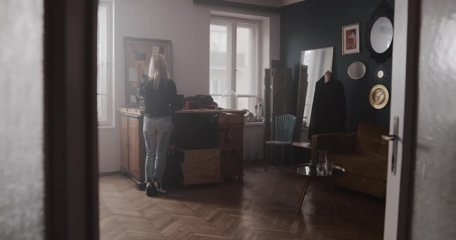 A woman is pacing the floor inside a shop