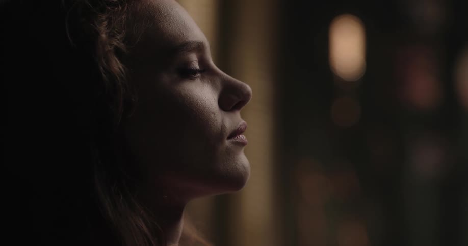 A woman is nodding her head back and forth