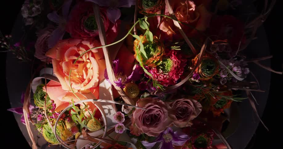 A bright light shines on a floral arrangement