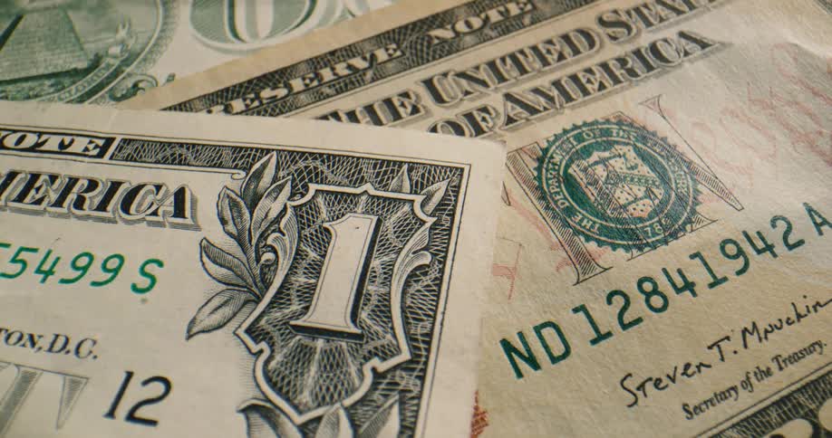 A one dollar bill on top of a ten