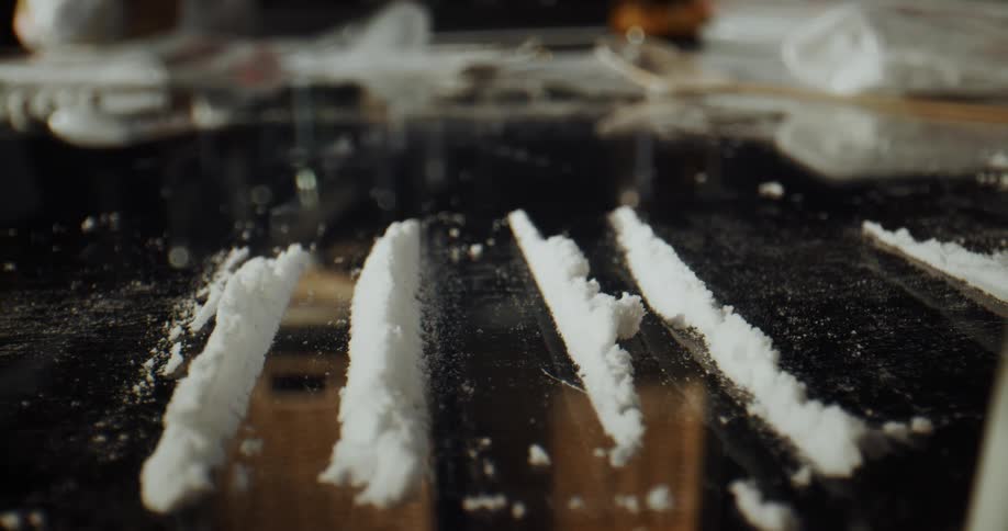 Lines of cocaine are laid out on a table