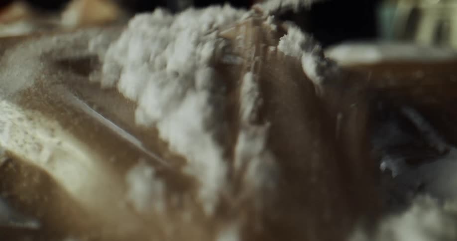 Close up of a sharp knife cutting open a cocaine package