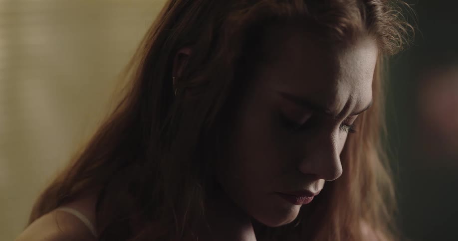 Sad and lonely young redhead woman almost crying