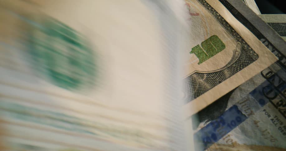 Multiple pieces of currency are put on a table