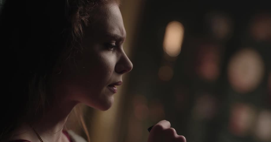 Angry young woman smoking a joint outdoors at night
