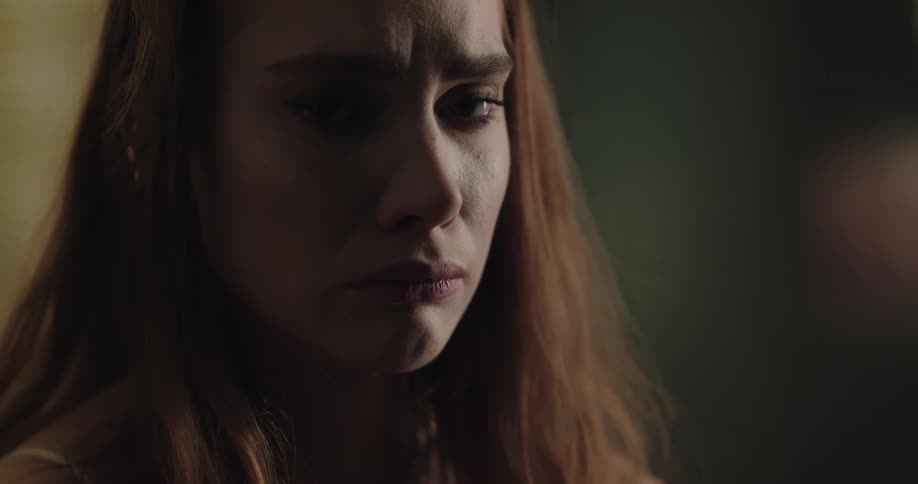 Young redhead woman crying with a sad expression on her face