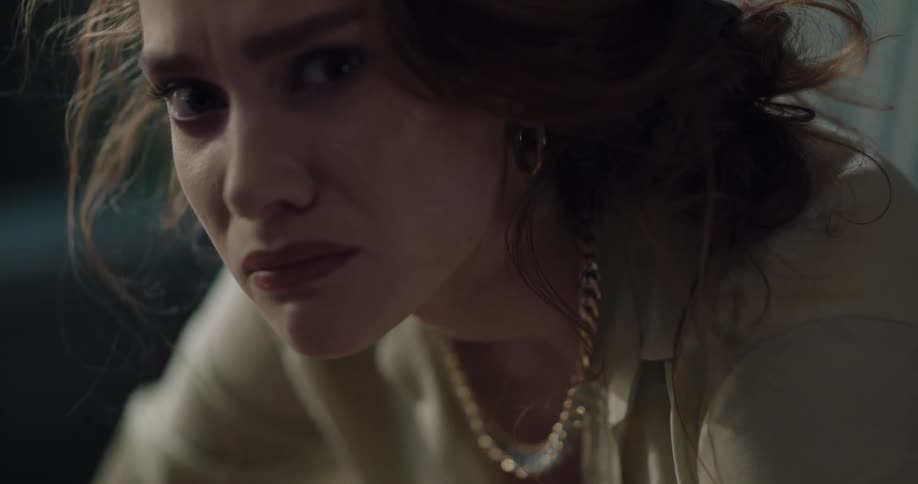 Young redhead woman with messy hair with a sad and distressed facial expression