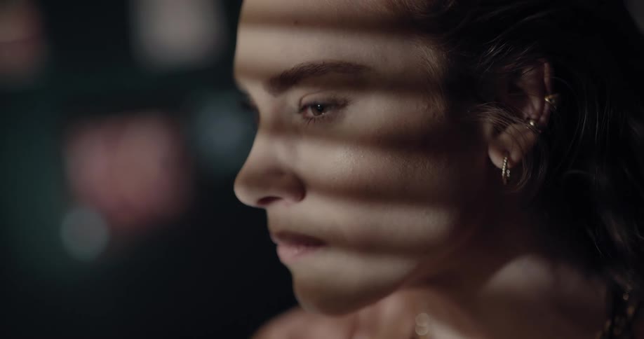 A woman is nervous as she looks out the window