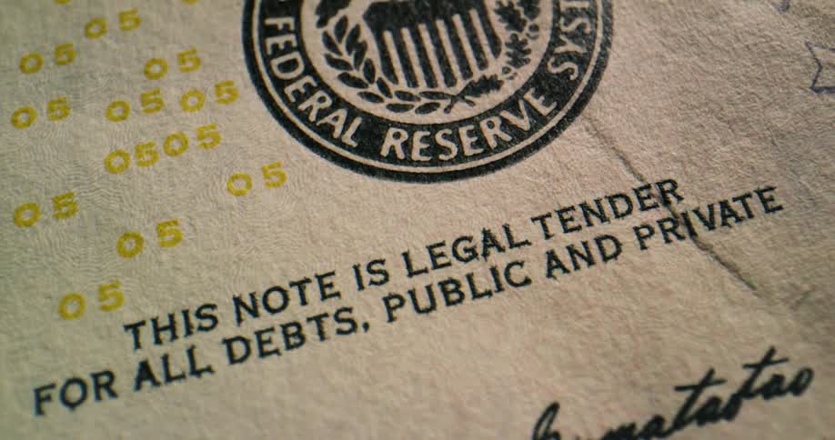 The markings and lettering of a us five dollar bill