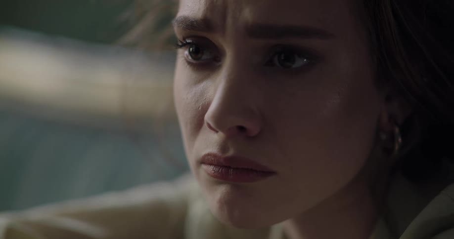 Young beautiful woman looking around with a sad face