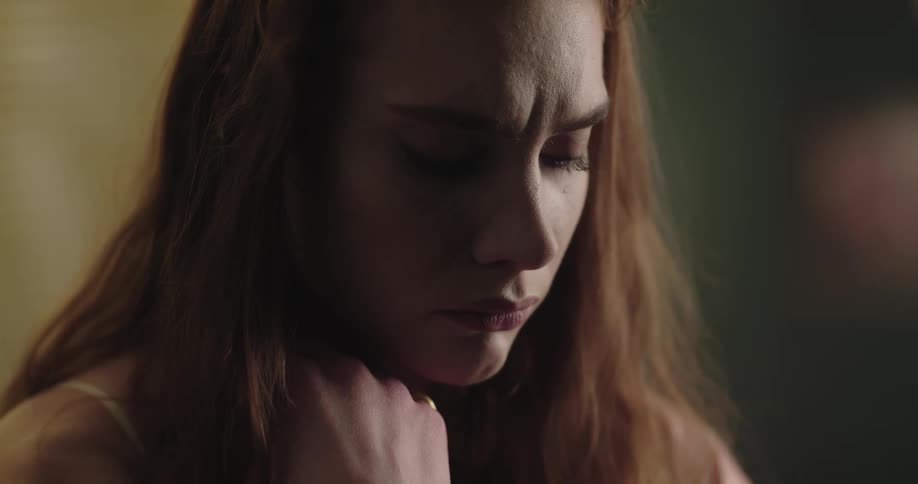 Young redhead woman with a worried expression on her face
