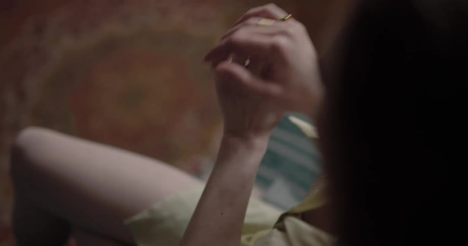 A woman waves her fingers together