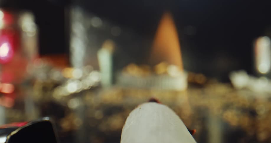 A person lights a cigarette