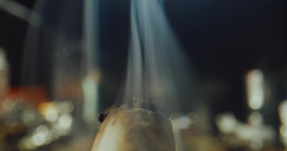 A person lights the cigarette with a lighter