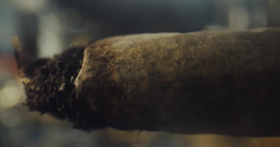 Smoke rises as a marijuana joint burns