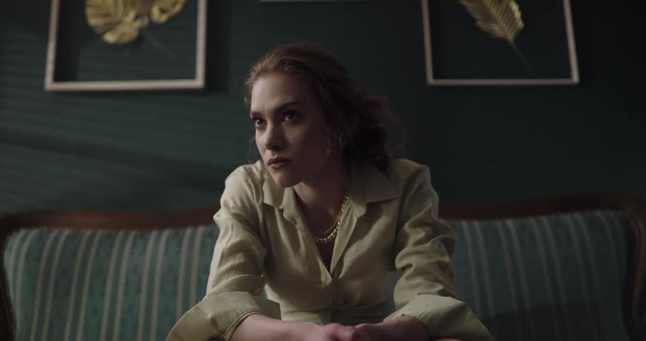 Young fancy beautiful woman with a distressed and angry facial expression sitting on the couch